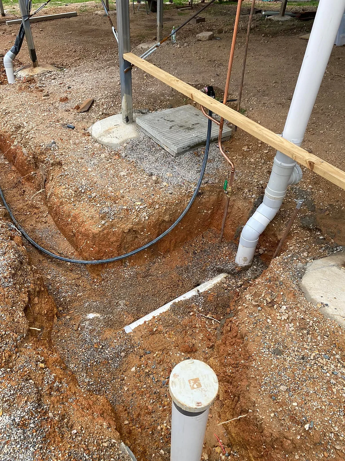 Trench with new PVC drainage risers